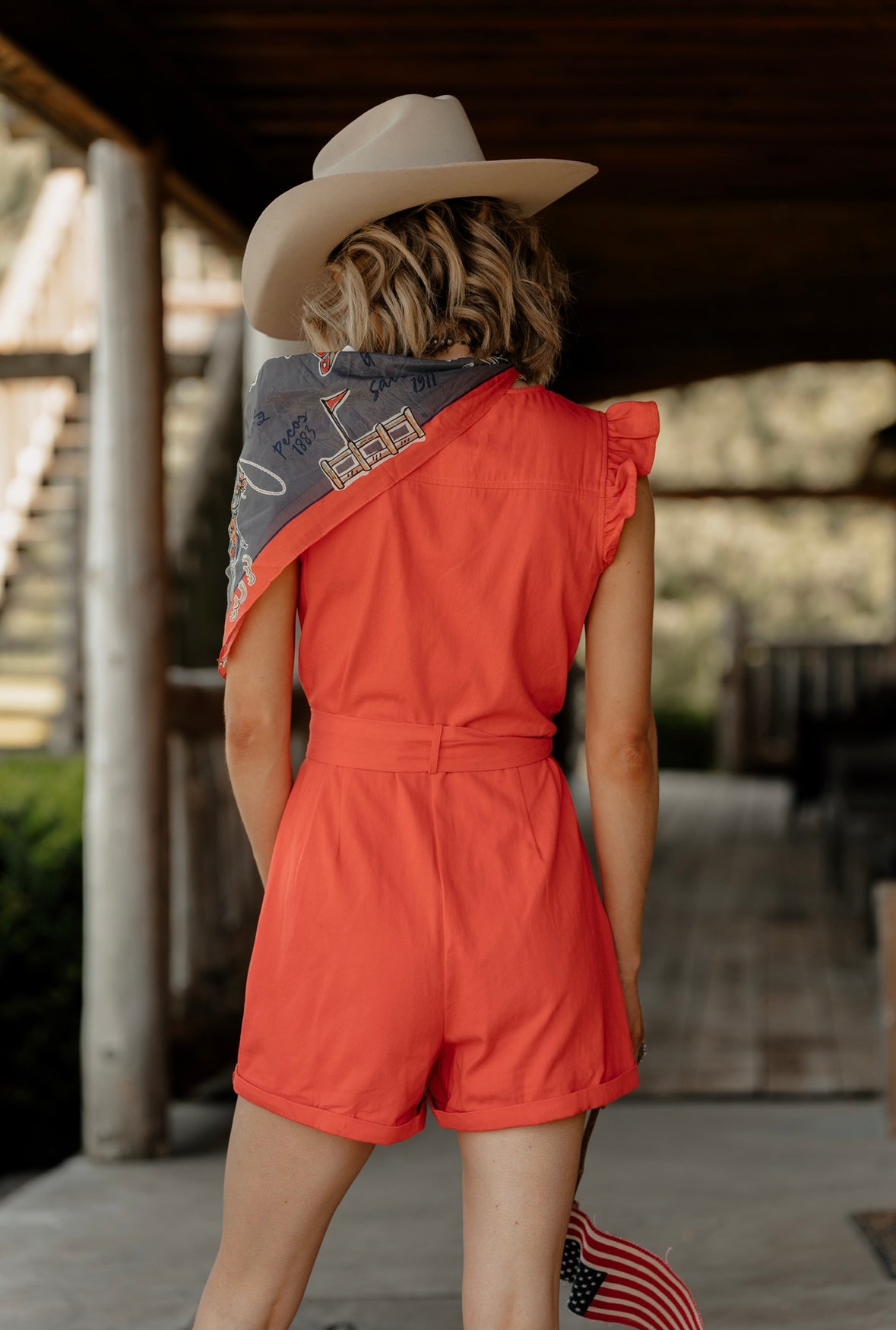 REd Romper with ruffle sleeve at shoulder