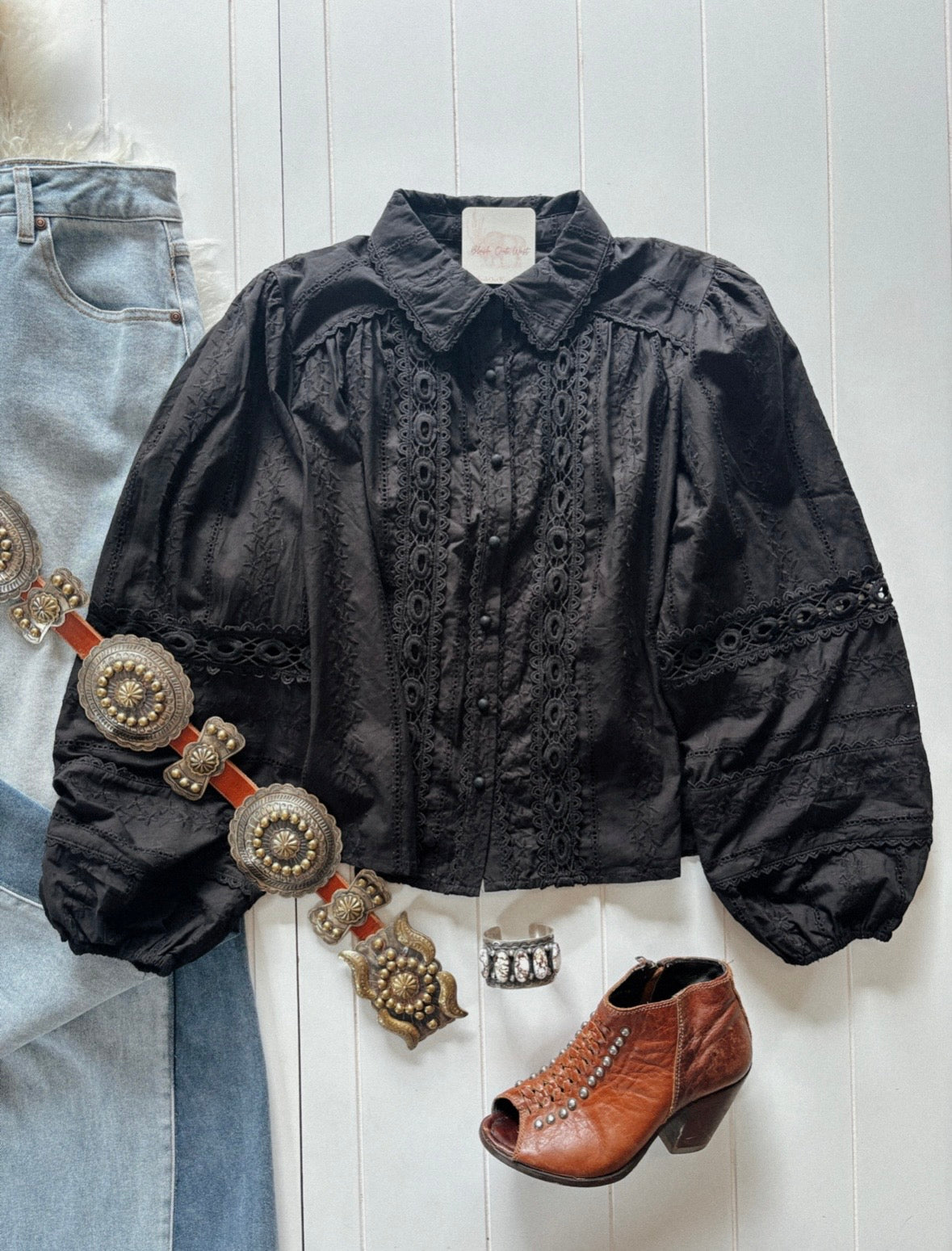 A black cotton eyelet blouse with lace detail