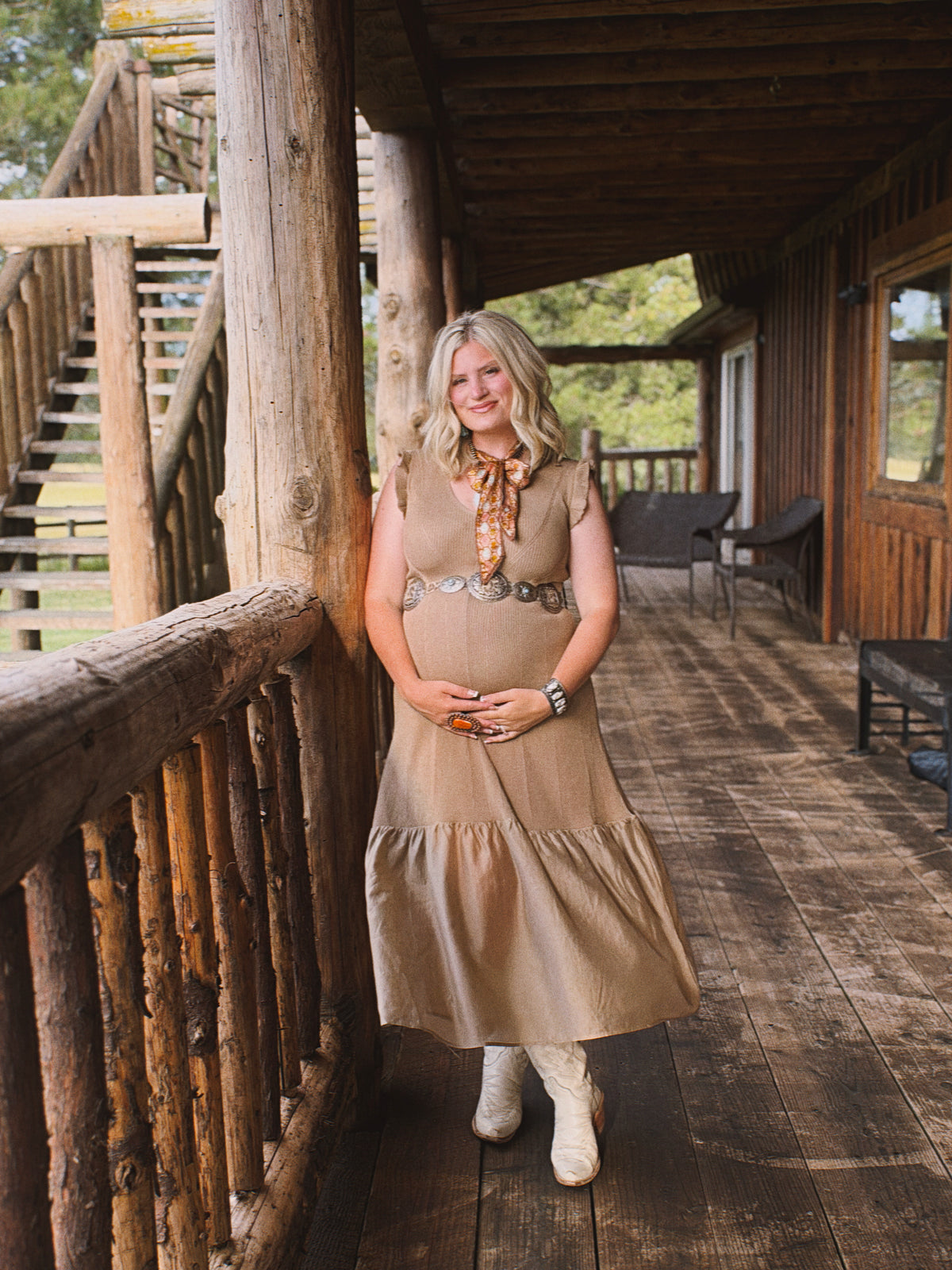 A taupe body-con dress with a ruffled hem, styled with western boots