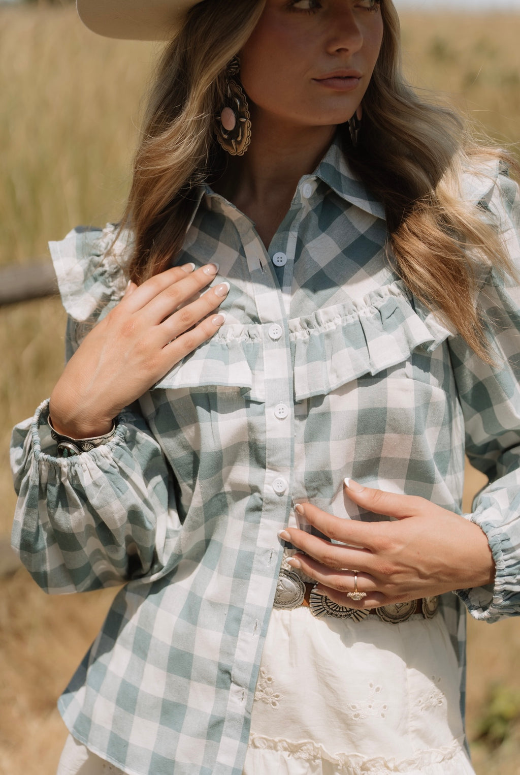 Woman wearing a plaid shirt in a field