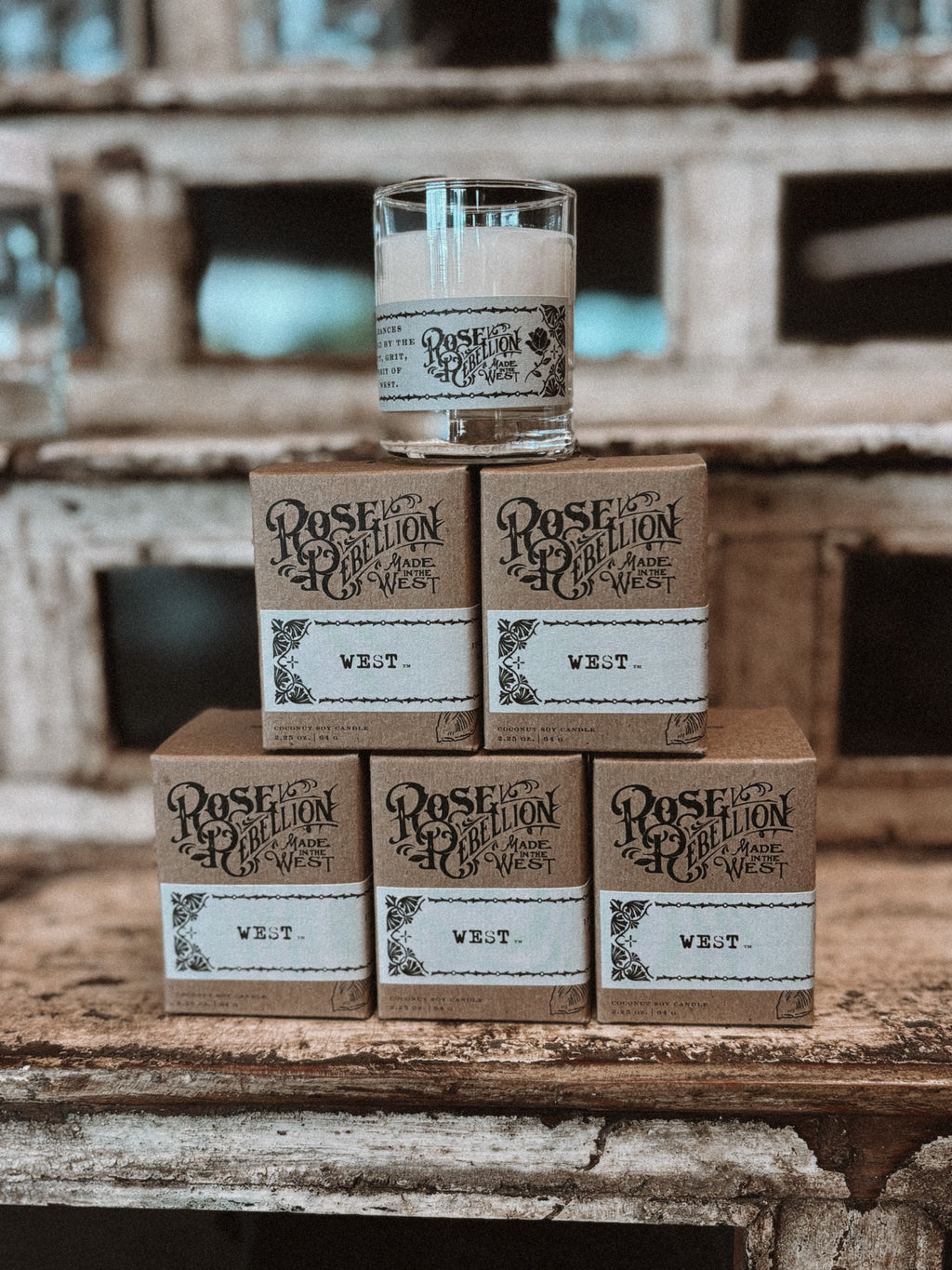 Stack of wooden boxes w/ R. Rellion Cancle branding on a rustic wooden surface.