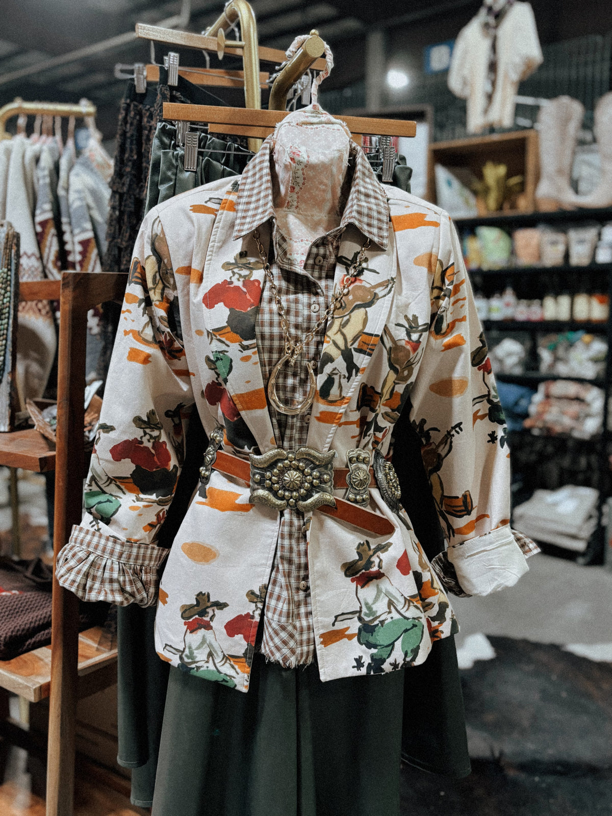 A retro cowboy print blazer on a mannequin