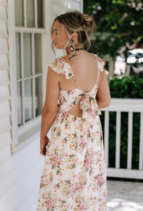 Woman wearing a floral dress on a porch