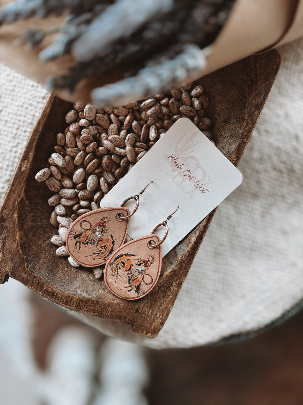 Earrings by XOXO leather bronc 
