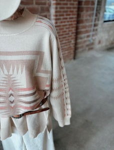 Mock neck cross sweater with slight bubble sleeve in creams, pink, taupes. Soft and cozy 